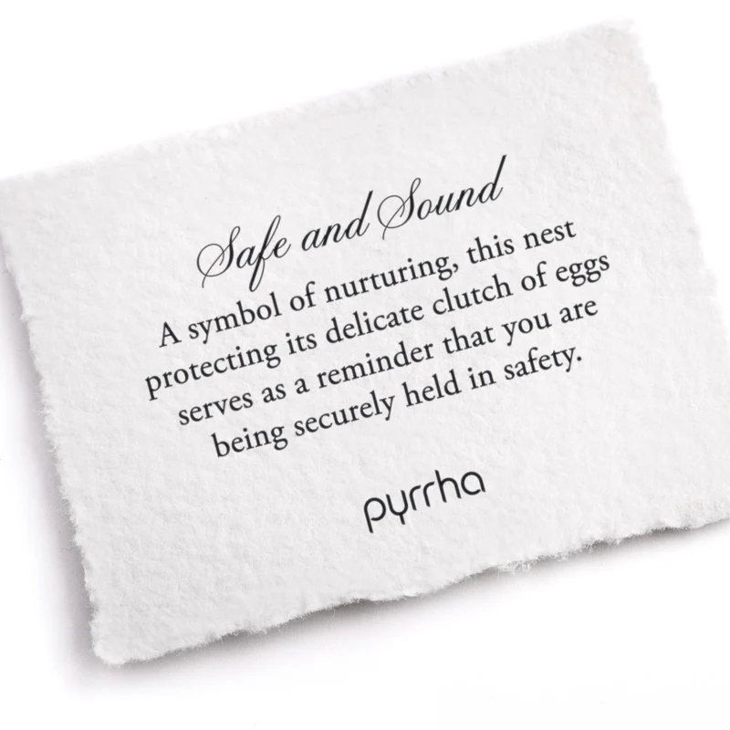 A Pyrrha note describing the Safe and Sound talisman. It reads, "A symbol of nurturing, this nest protecting its delicate clutch of eggs serves as a reminder that you are being securely held in safety."