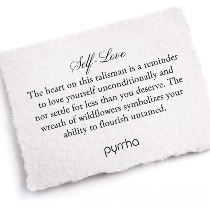 A Pyrrha note describing the Self-Love talisman. It reads, "The heart on this talisman is a reminder to love yourself unconditionally and not settle for less than you deserve. The wreath of wildflowers symbolizes your ability to flourish untamed."