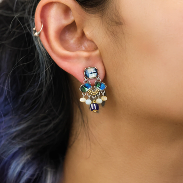 Plated Sterling Silver Earring Featuring an Intricate Design with mixes of multicoloured Textile thread and multiple sizes of gemstones and beads. The main colours include tones of blue, green and white. | on model