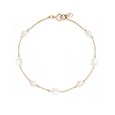 A dainty gold bracelet with alternating oval and round pearls