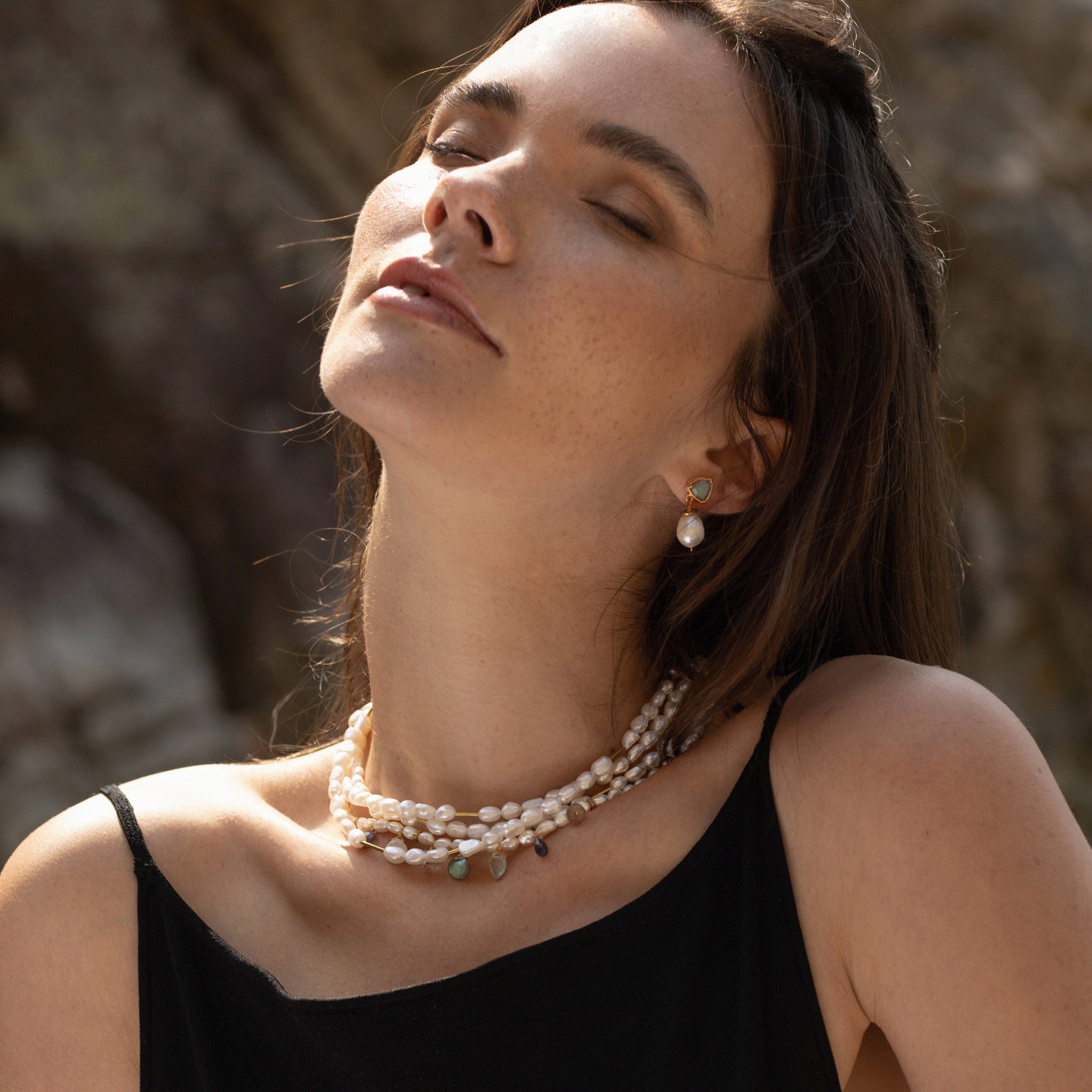  Storm Necklace features beautiful Freshwater Pearls with a wintry rainbow of gemstone drops - including Labradorite, Iolite, Aquamarine, Green Amethyst &amp; Moonstone. Reclaimed brass beads are asymmetrically spaced throughout  | on model