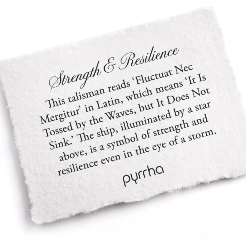 A Pyrrha note describing the Strength & Resilience talisman. It reads, "This talisman reads 'Fluctuat Nec Mergitur' in Latin, which means 'It Is Tossed by the Waves, but It Does Not Sink.' The ship, illuminated by a star above, is a symbol of strength and resilience even in the eye of a storm."