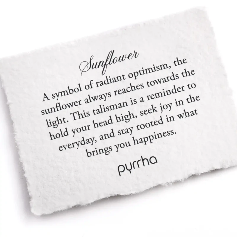 A Pyrrha note describing the Sunflower talisman. it reads, "A symbol of radiant optimism, the sunflower always reaches towards the light. This talisman is a reminder to hold your head high, seek joy in the everyday, and stay rooted in what brings you happiness."