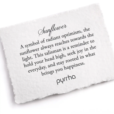 A Pyrrha note describing the Sunflower talisman. It reads, "A symbol of radiant optimism, the sunflower always reaches towards the light. This talisman is a reminder to hold your head high, seek joy in the everyday, and stay rooted in what brings you happiness."
