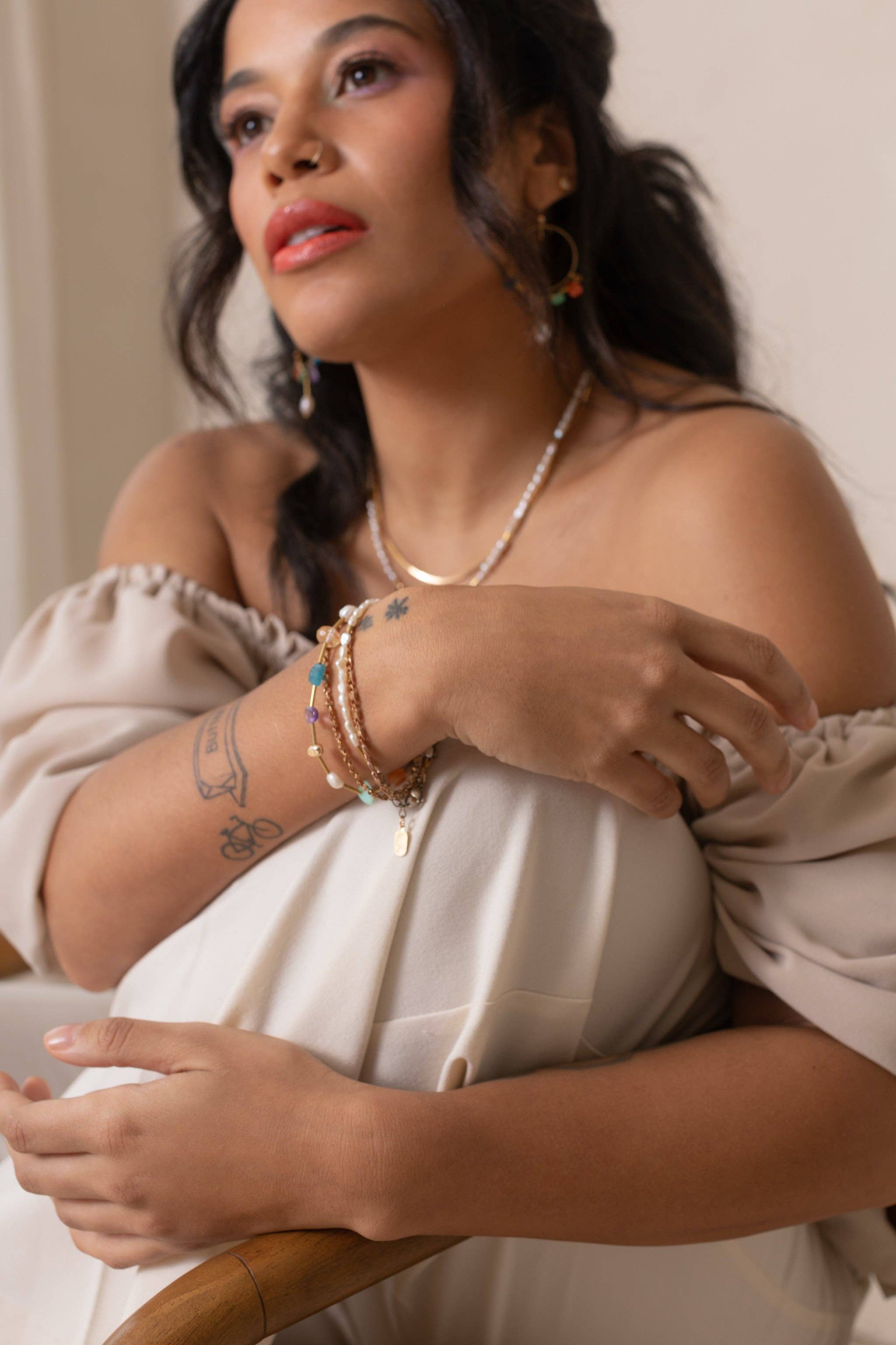 This handmade Surya Bracelet features a fun and beachy multicolour design with warm brass accents. featuring Chrysoprase, Carnelian, Apatite, Amethyst, Freshwater Pearl, and gold-plated brass nuggets. | on model