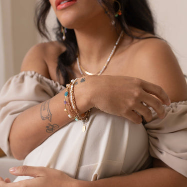 This handmade Surya Bracelet features a fun and beachy multicolour design with warm brass accents. featuring Chrysoprase, Carnelian, Apatite, Amethyst, Freshwater Pearl, and gold-plated brass nuggets. | on model