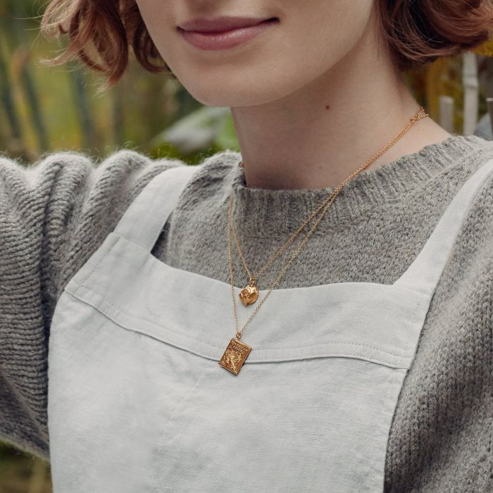 Gold Plated Silver Necklace with a Diamond shaped Pendant  with "Sweet Pea Seeds" written on it | On Model