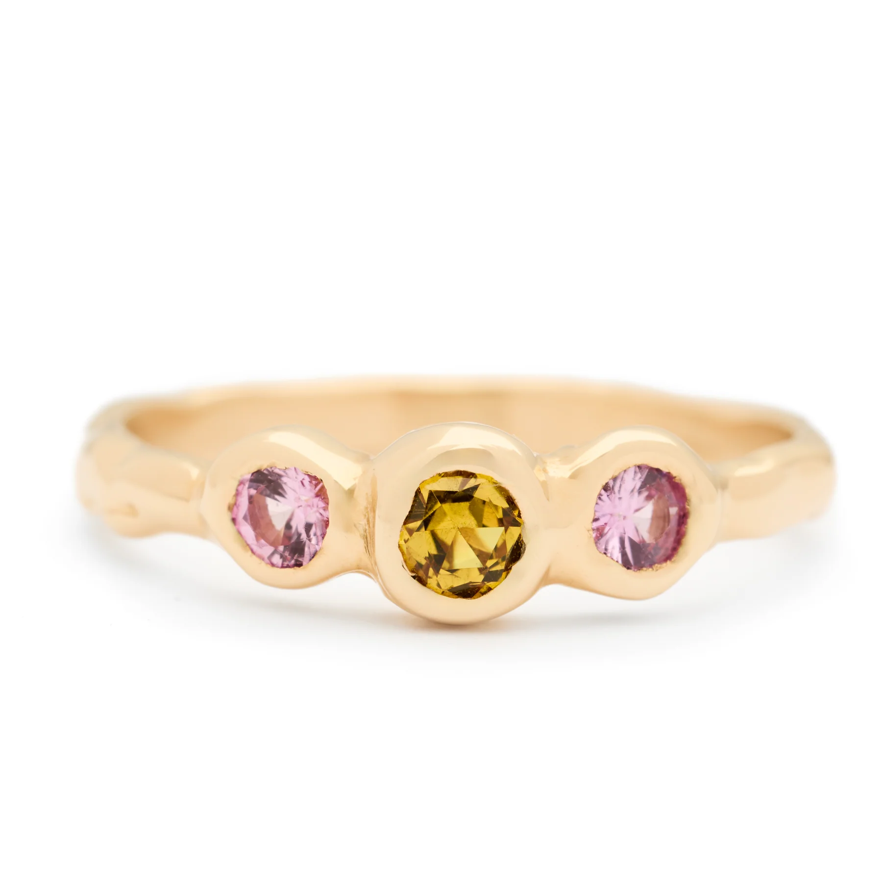 Yellow sapphire centre with two pink sapphires on either side all set in a one-of-a-kind ring mount hand-carved in 14k Yellow Gold