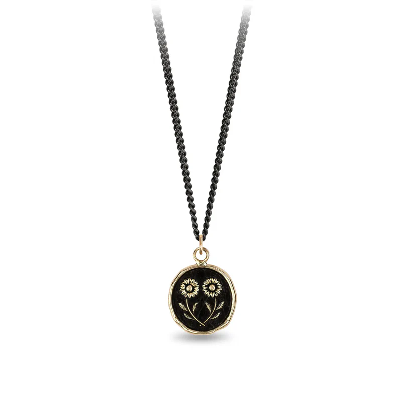 Black Sterling Silver necklace with a 14k yellow gold talisman depicting two daisies mirroring eachother at the stem