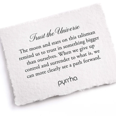 A Pyrrha Note describing the Trust the Universe talisman. It reads, "The moon and stars on this talisman remind us to trust in something bigger than ourselves. When we give up control and surrender to what is, we can more clearly see a path forward."