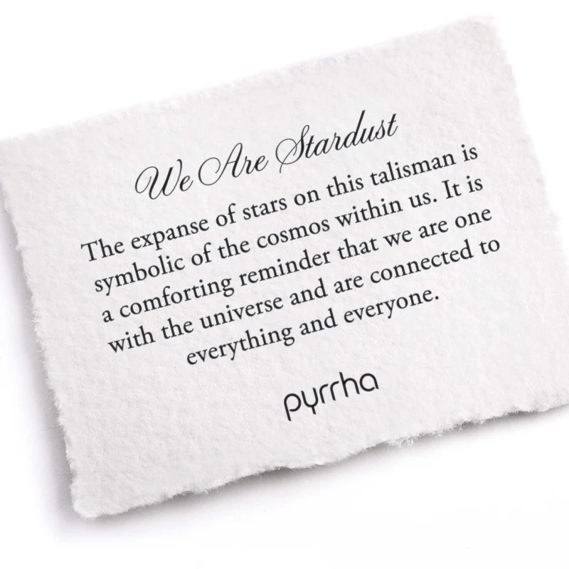 A Pyrrha Note describing the we are stardust talisman. It reads, "The expanse of stars on this talisman is symbolic of the cosmos within us. It is a comforting reminder that we are one with the universe and are connected to everything and everyone."