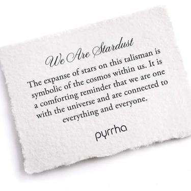 A Pyrrha Note describing the we are stardust talisman. It reads, "The expanse of stars on this talisman is symbolic of the cosmos within us. It is a comforting reminder that we are one with the universe and are connected to everything and everyone."