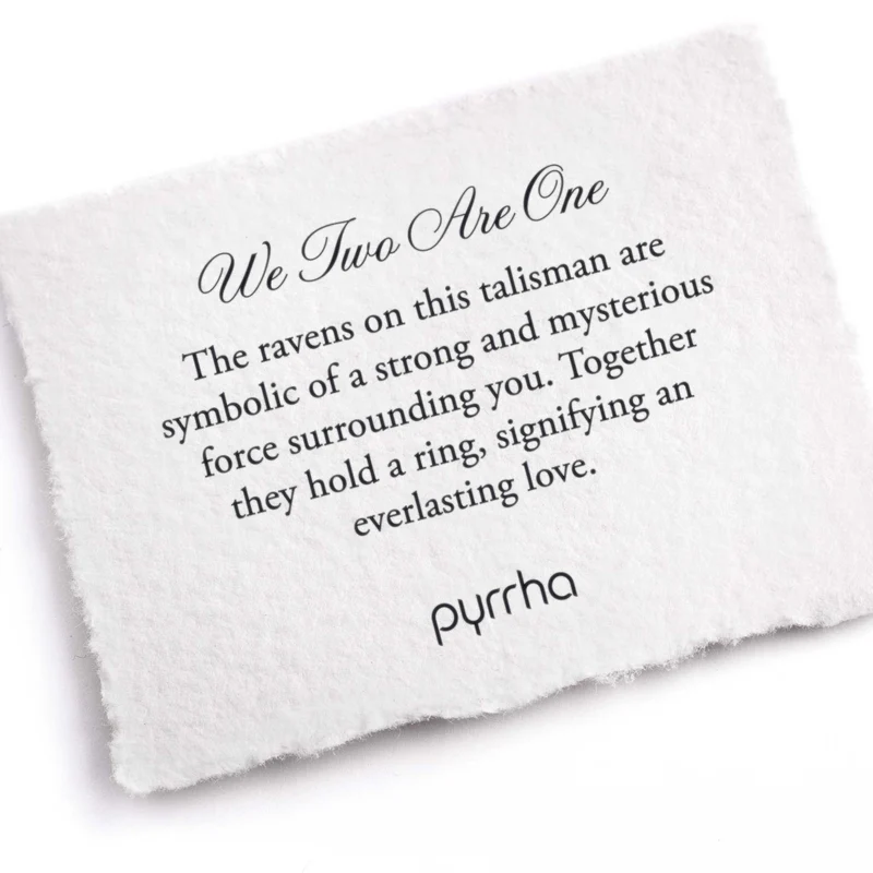 A Pyrrha Note describing the We Two Are One talisman. It reads, "The ravens on this talisman are symbolic of a strong and mysterious force surrounding you. Together they hold a ring, signifying an everlasting love."