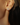 14k Yellow gold plated sterling silver studs  with a pear cut white topaz gemstone  | on model