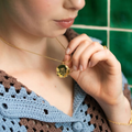 Gold Plated Silver Necklace with a Pendant engraved with a woman swimming in teh water, with floral accents