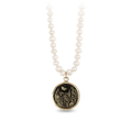 Knotted ivory freshwater pearl necklace with a 14k Yellow gold talisman depicting a Butterfly flying over a field of varying flora and plants