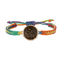 Rainbow Braided Bracelet with a bronze talisman depicting a butterfly flying above a field of various flora and grass