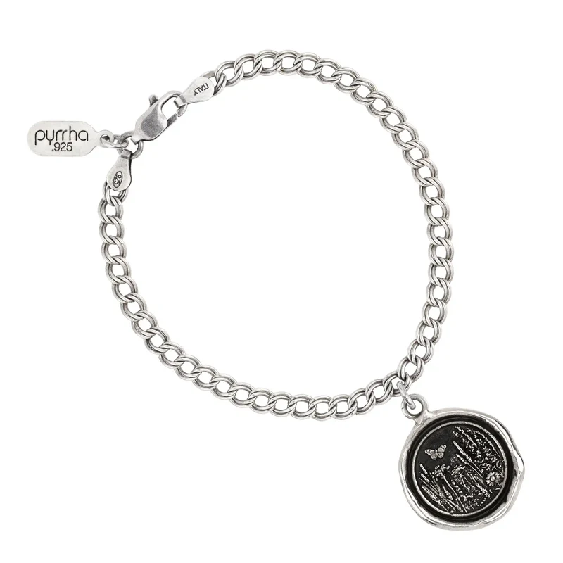 Sterling Silver chain Bracelet with a talisman depicting a Butterfly above a large field of flowers and plants.