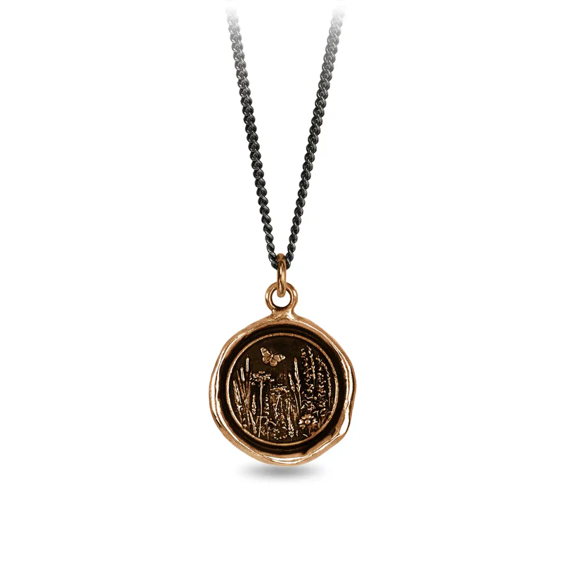 Bronze Necklace with a talisman depicting a Butterfly above a large field of flowers and plants.