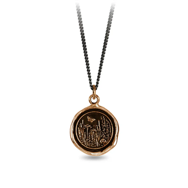 Bronze Necklace with a talisman depicting a Butterfly above a large field of flowers and plants.