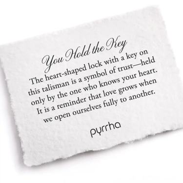 A Pyrrha note describing the You Hold the Key talisman. It reads, "The heart-shaped lock with a key on this talisman is a symbol of trust—held only by the one who knows your heart. It is a reminder that love grows when we open ourselves fully to another."