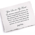 A Pyrrha Note describing the You Live in My Heart talisman. it reads, "The ultimate expression of love, the ribbon-wrapped heart featured on this talisman reads 'You Live in My Heart.' It tells our loved ones that even when they aren't physically present, we carry them with us."