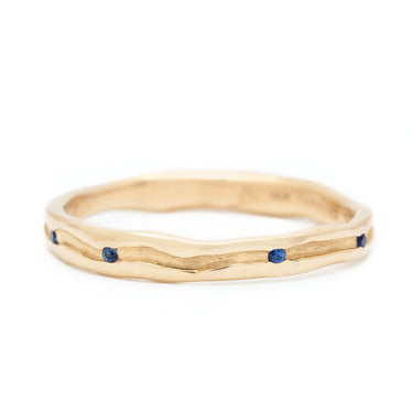 Trough Ring with Seven Sapphires - 14k Fairmined Yellow Gold Band with trough engraved throughout centre of band, featuring seven blue sapphires