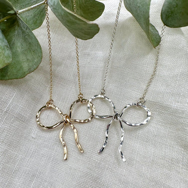 Hammered metal bow necklace