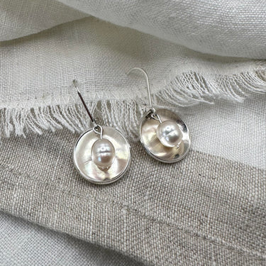 Pearl Glow Earrings - These domed disks reflect the silky-glow of the Pearls they hold. An ethereal style that will radiate beauty and femininity.