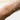 This 18-karat gold bracelet features two distinctive strands—one adorned with faceted gold beads and the other with small diamond-cut discs | on model
