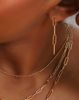 Gold-filled chain earrings, worn on a model. 