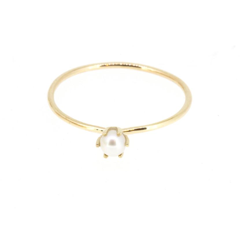  14-karat gold solitaire band featuring a tiny round white pearl
