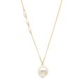 A large baroque pearl pendant anchors a 14-karat gold chain with a trio of baby keshi pearl on one side. 