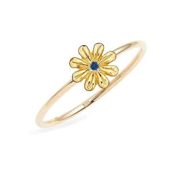 A daisy flower, cast in 14K gold, sits atop a  gold band, featuring a Blue Sapphire center.