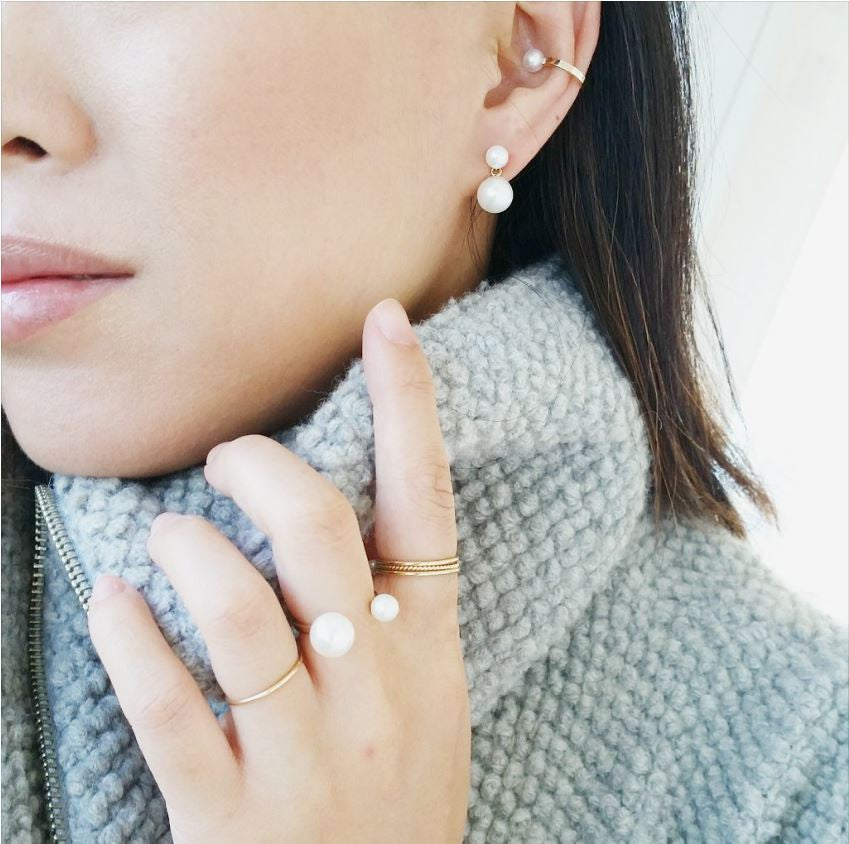 A pair of double pearl 14k Gold earrings featuring four lustrous pearls | on model