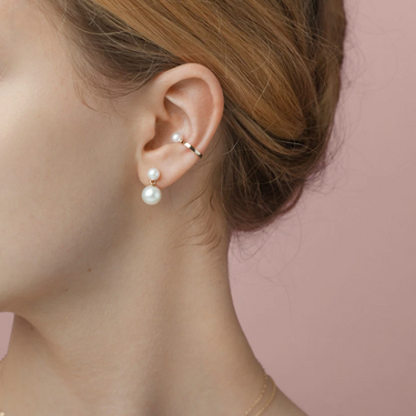 A pair of double pearl 14k Gold earrings featuring four lustrous pearls | on model