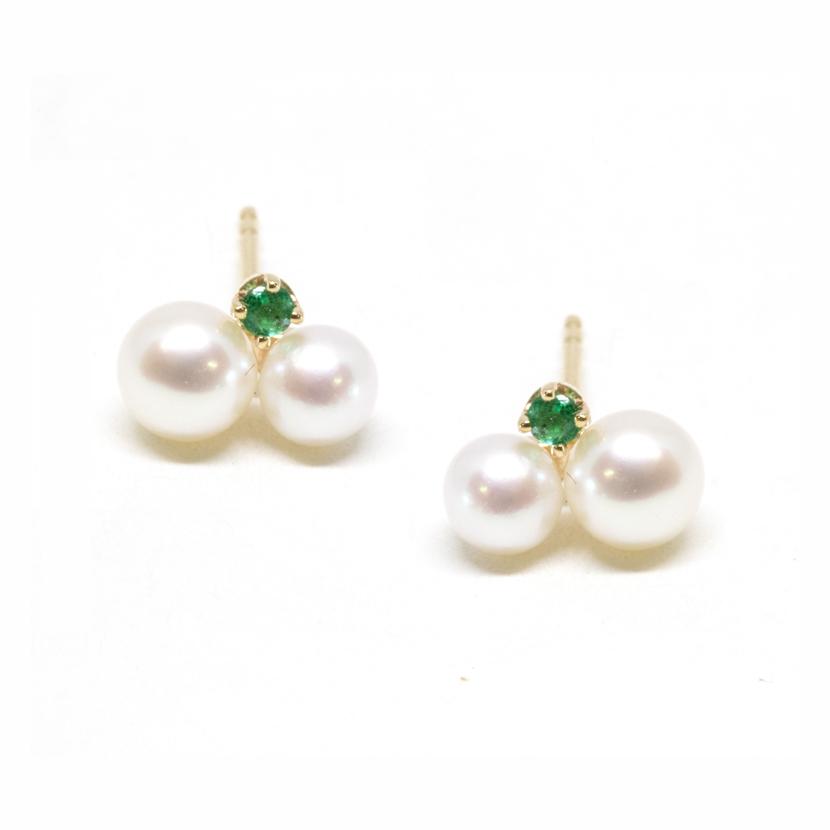 Pearl studs with a vibrant gemstone nested along the side of two lustrous pearls creating cluster pearl earrings