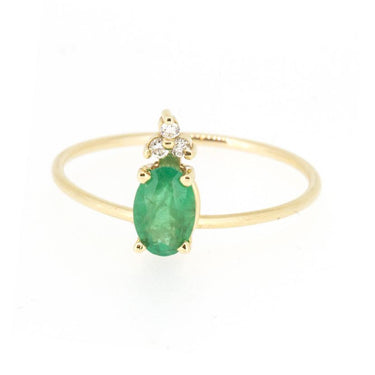 14k Yellow Gold Ring showcasing a prong-set oval-shaped genuine emerald with three diamonds, Set at the top of a slim gold band  
