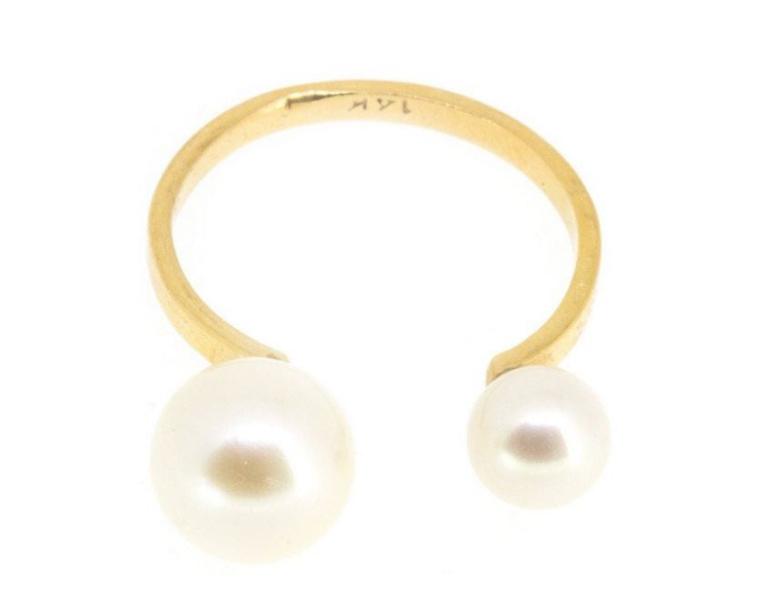  Two round freshwater cultured pearls atop a handcrafted 14-karate solid gold band. 