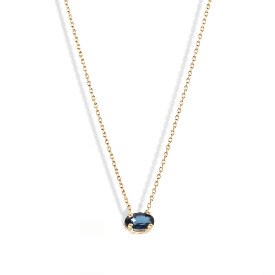 A vibrant royal blue sapphire pendant is the centre of attention on a slim 14-karat gold chain