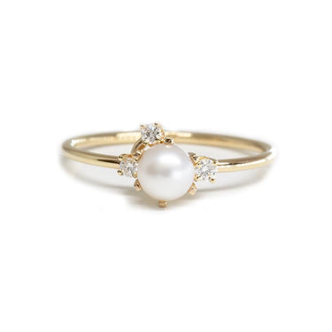 14k Yellow gold Ring featuring A cluster of diamonds adorning a white pearl in the center