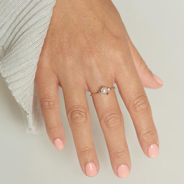 14K Yellow Gold cluster ring showcasing a white pearl at its center, adorned by Two Rubys and a pink sapphire | on model