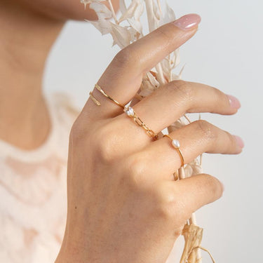 14k Yellow skinny gold ring with a sweet petite oval shaped pearl in the center. | on model