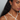 A pull through earring style featuring a pair of lustrous petite oval shaped pearls | on model