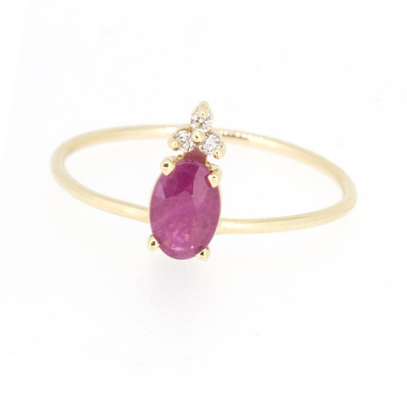14-karat gold ring showcasing a  prong-set oval-shaped genuine Ruby gemstone with three iamonds.