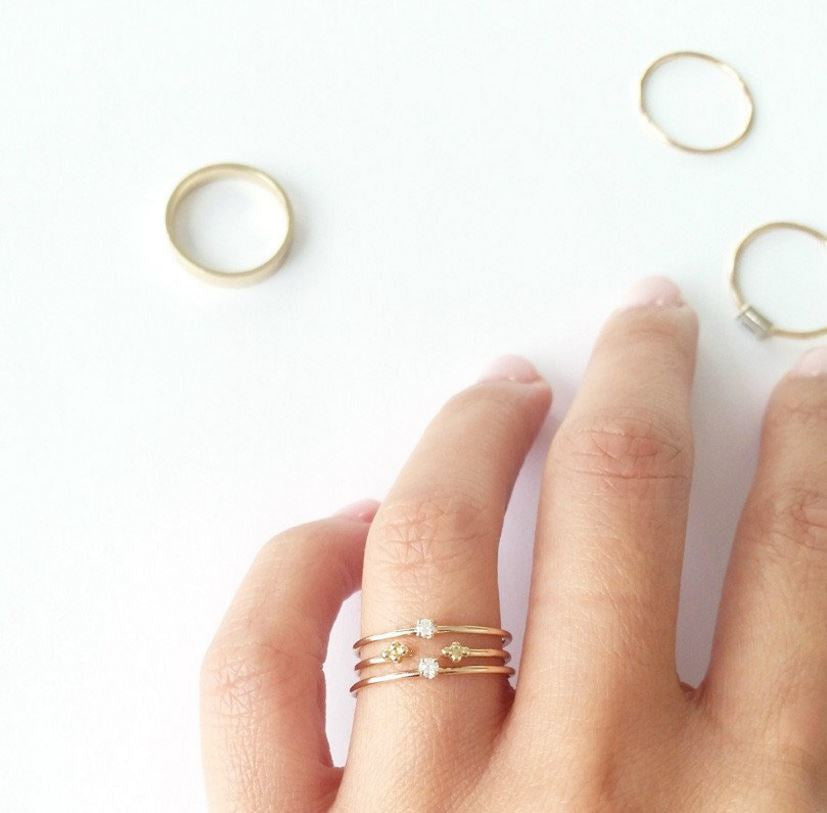 This ring features a small 2mm brilliant-cut diamond set on a slim 14K recycled gold band | on model
