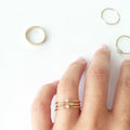 This ring features a small 2mm brilliant-cut diamond set on a slim 14K recycled gold band | on model
