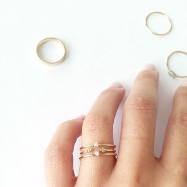 This ring features a small 2mm brilliant-cut diamond set on a slim 14K recycled gold band | on model