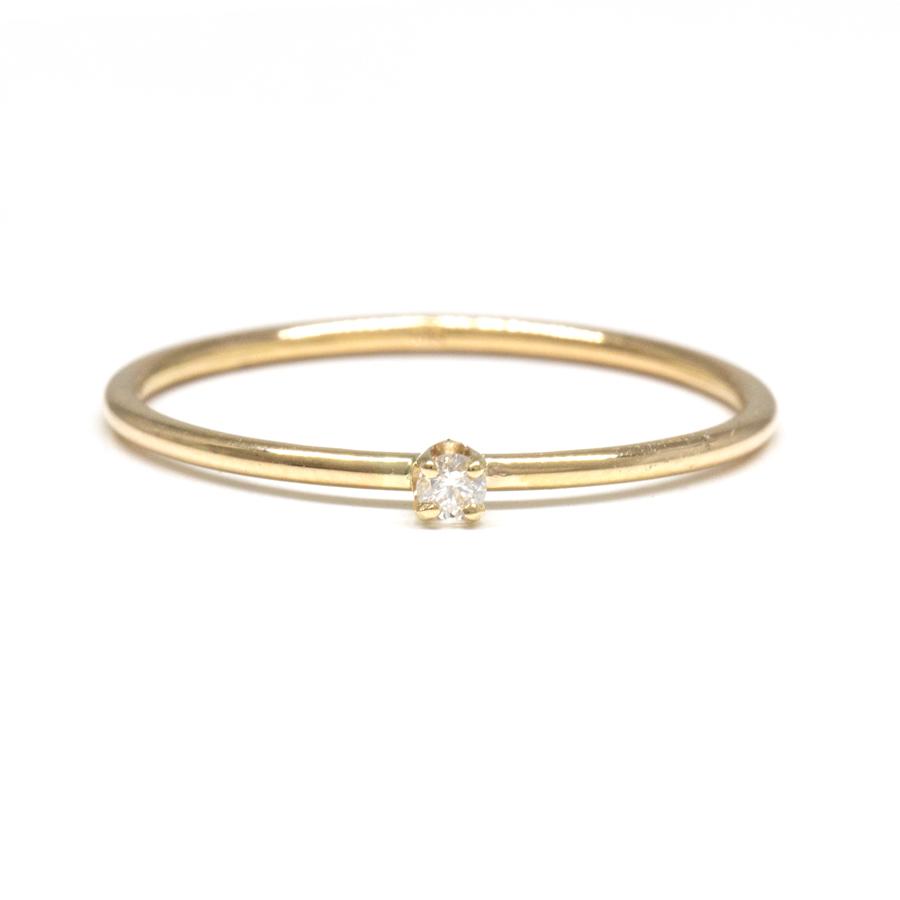 This ring features a small 2mm brilliant-cut diamond set on a slim 14K recycled gold band