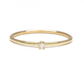 This ring features a small 2mm brilliant-cut diamond set on a slim 14K recycled gold band